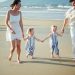 Family walking on a beach at sunset
